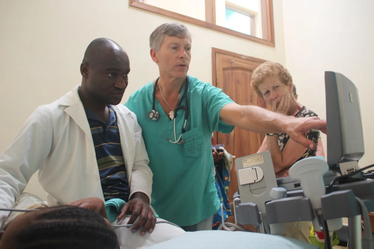 Dr Gabriel Kissima and volunteer cardiologist Dr Reed Shnider performing a heart echo on Beatrice