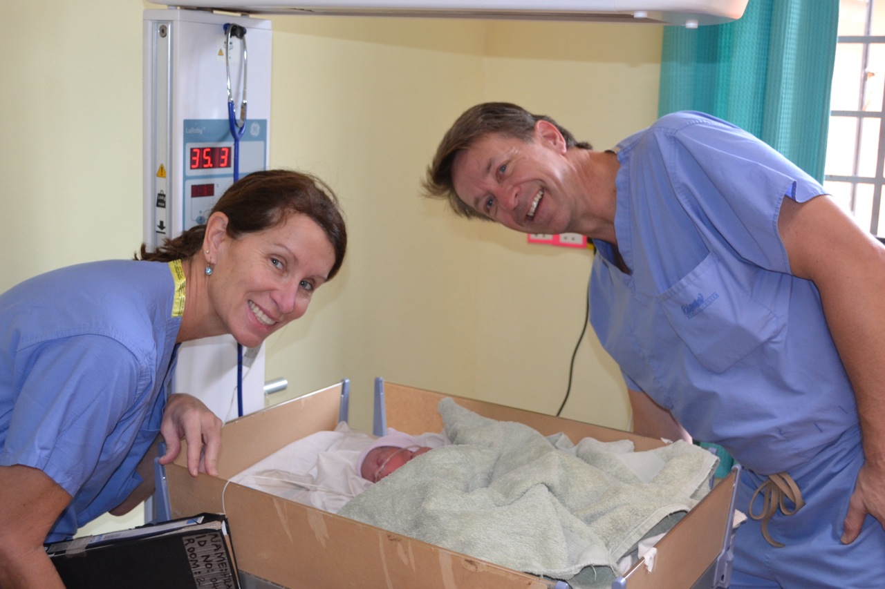 Dr. Mark and Dr. Monica with one of the triplets