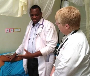 Dr. Apple and Dr. Badyana with their patient