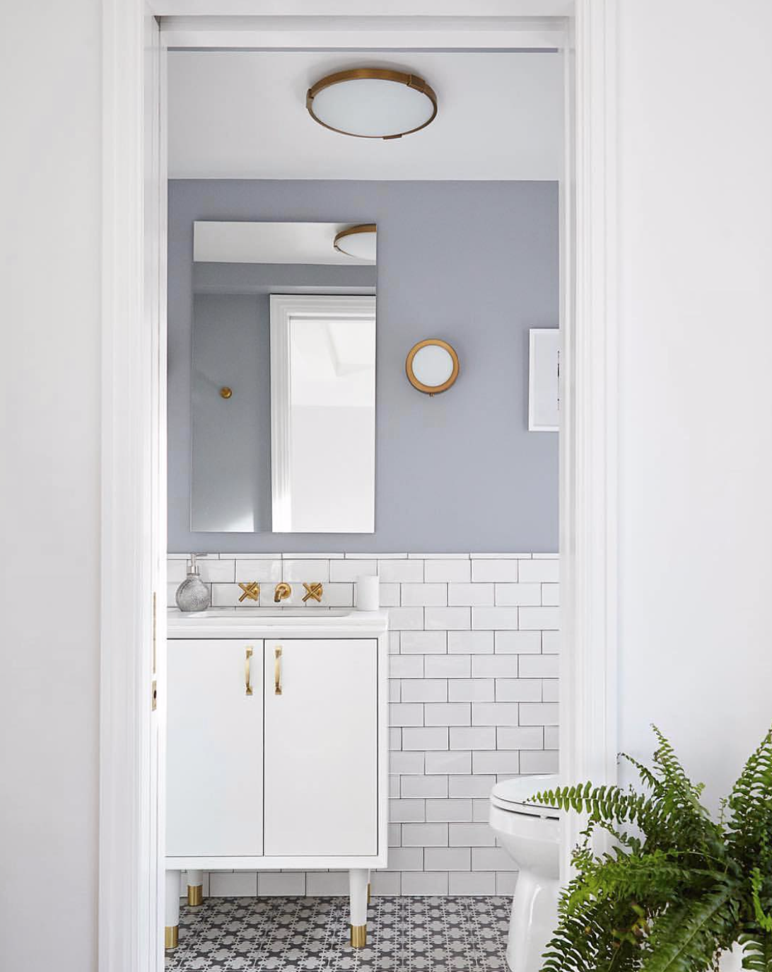   @lra_architecture  created a bright and airy powder room through the combination of sleek fixtures and a clean color palette. 