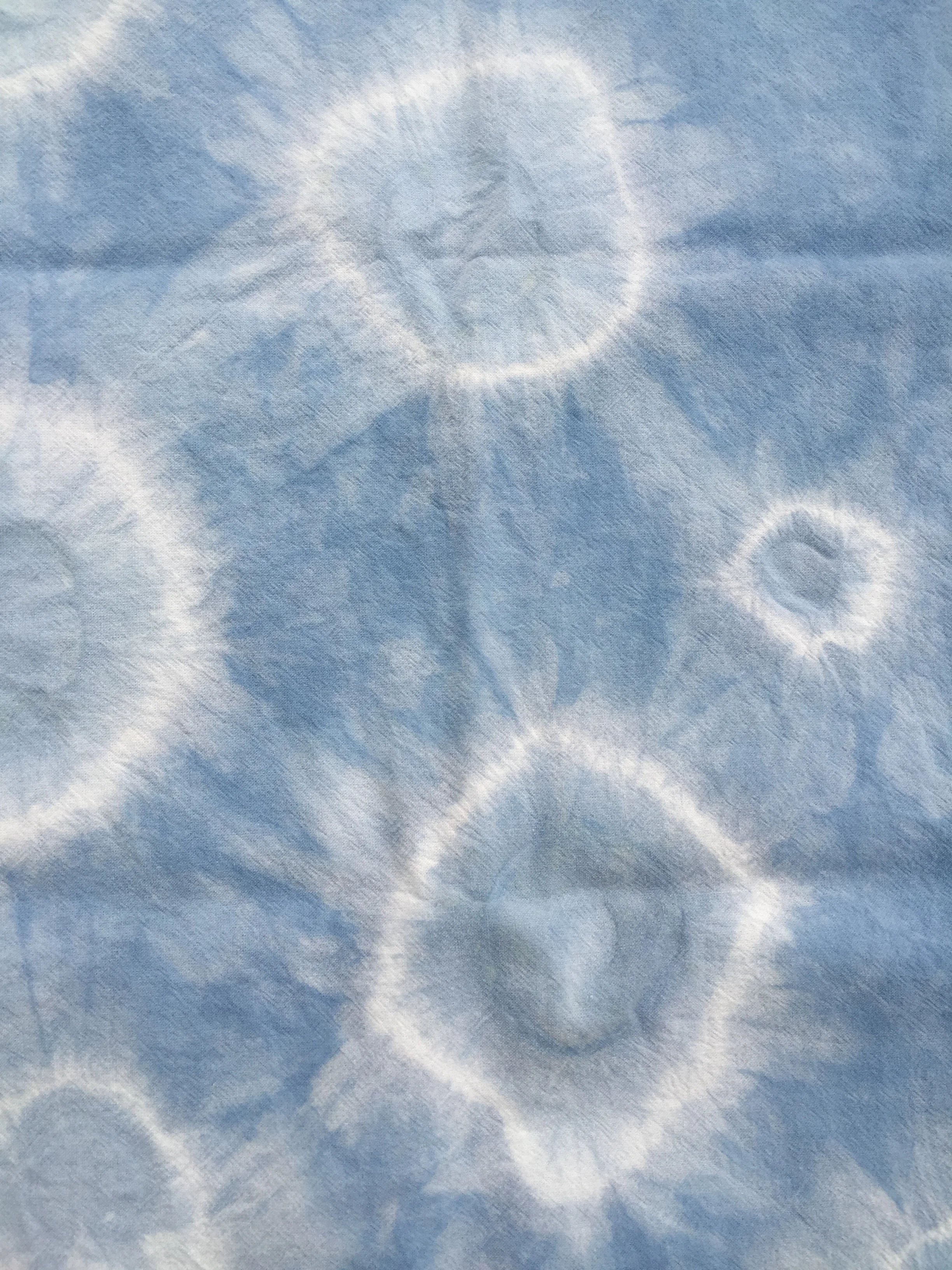 Silk scarf prepared with washers bound by rubber bands.