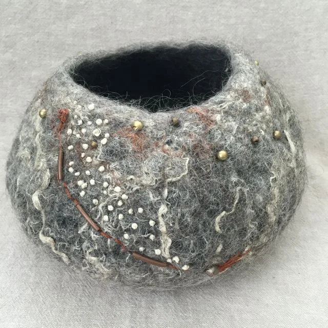 Wet felted vessels made with un-dyed wool and embellished with beads and embroidery.
