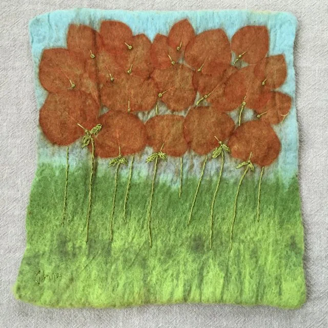 Wet fe;ted. eco printed wall hanging, embellished with embroidery.