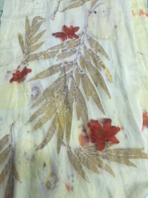 Print of yellow coreopsis blossom and grevillea on silk jersey.