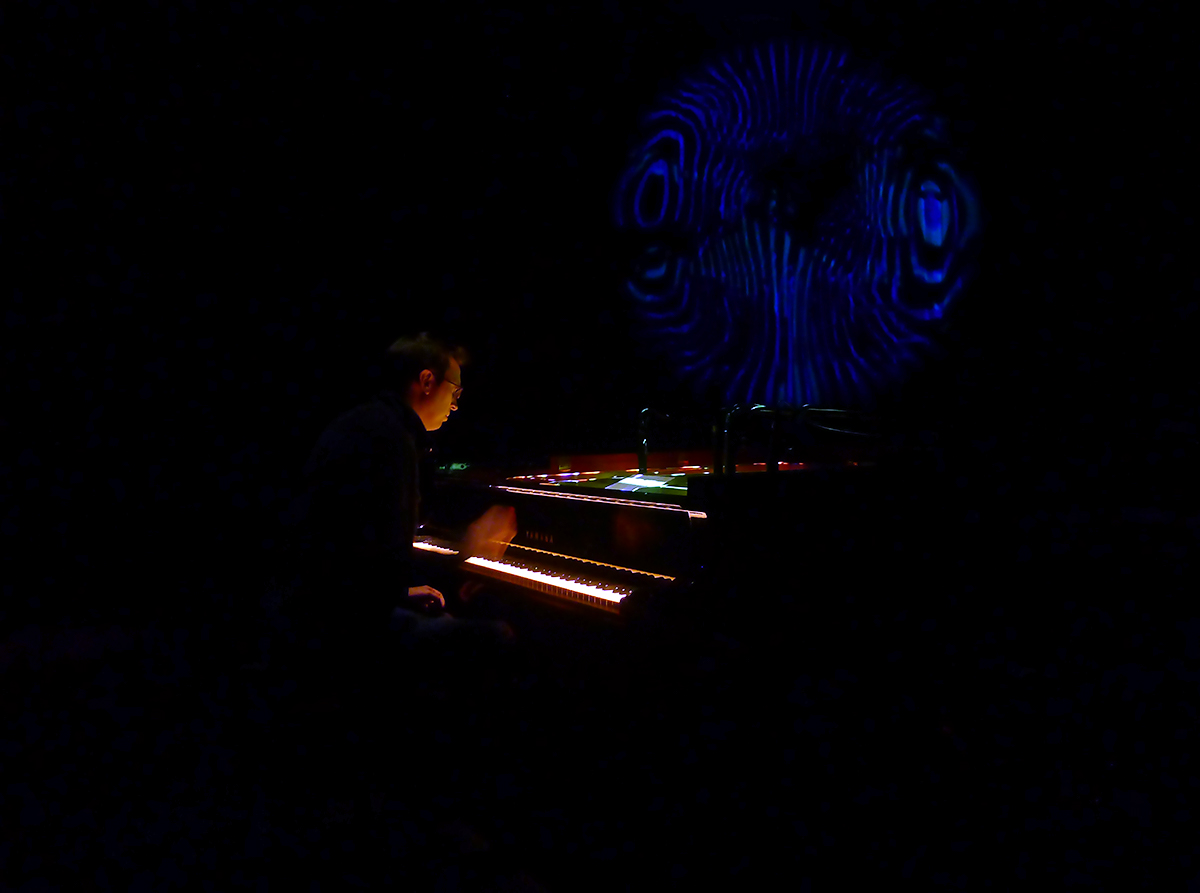 R. Andrew Lee performing Randy Gibson's The Four Pillars Appearing from The Equal D under Resonating Apparitions of the Eternal Process in The Midwinter Starfield at the ATLAS performance space with projections by Oscar H Scott | Photo by Randy Gibson