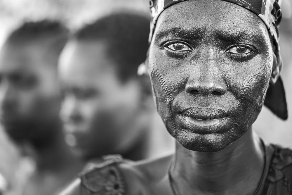 A proud traditional Nuer woman. Her eyes give away the challenges of her life.