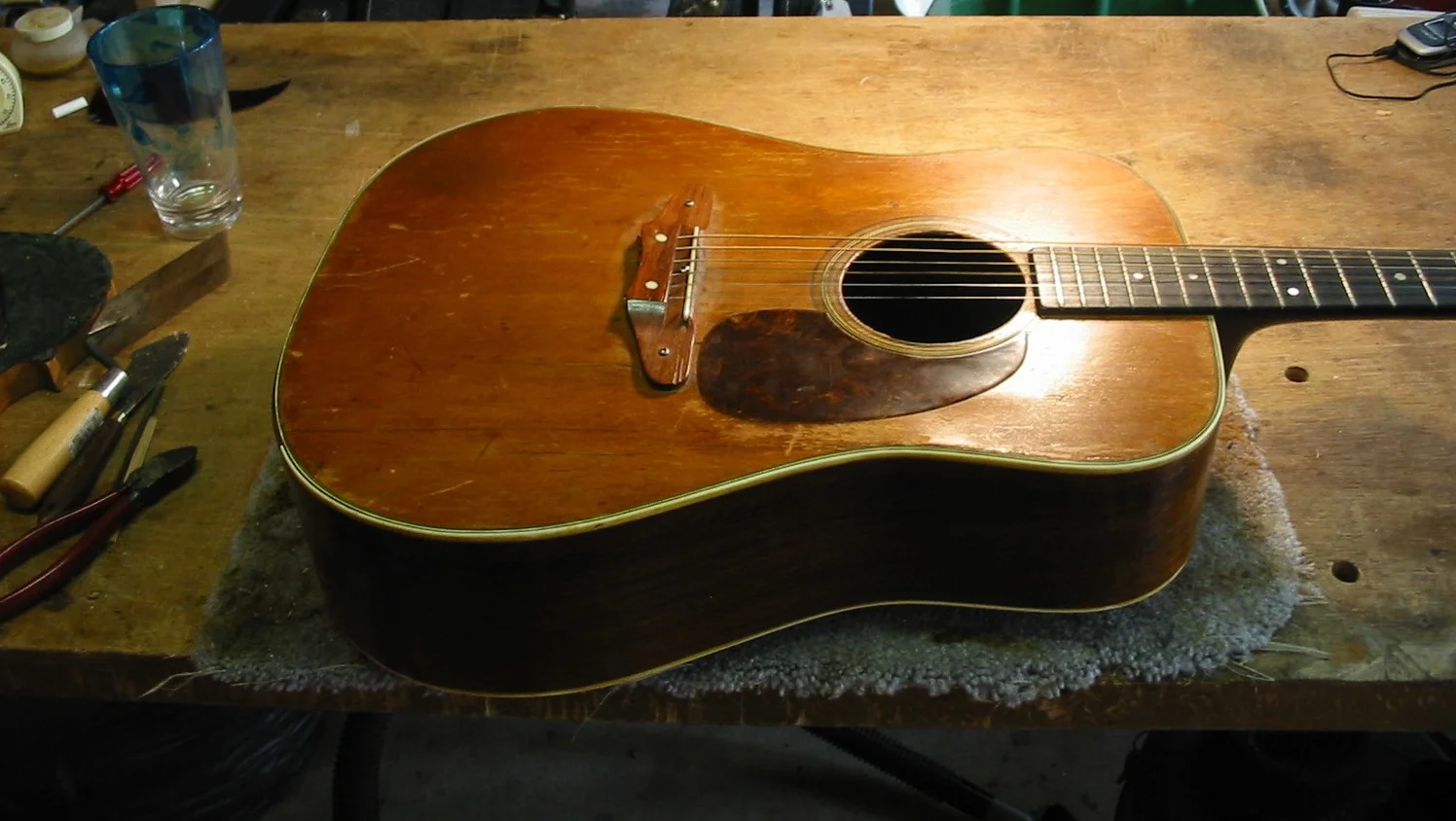  This guitar came in with&nbsp;the top coming off, a&nbsp;terrible bridge,&nbsp;broken and missing bracing and in need of a neck set.    
