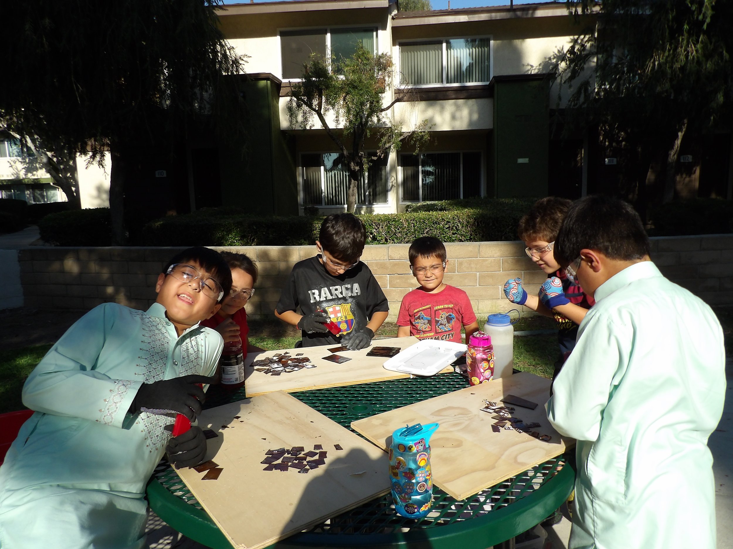 The boys learning to cut up the glass using hand tools...safety first!