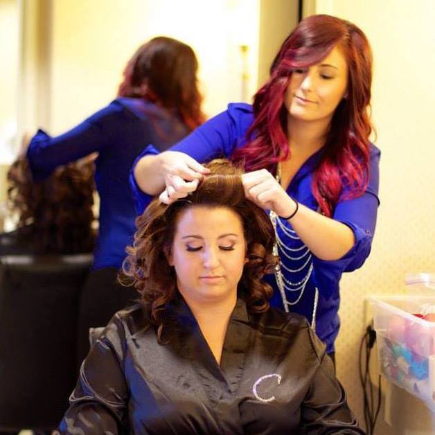 Prepping the beautiful bride Carolyn for her celebration of love. Photo captured by Mirror Image Photography .
