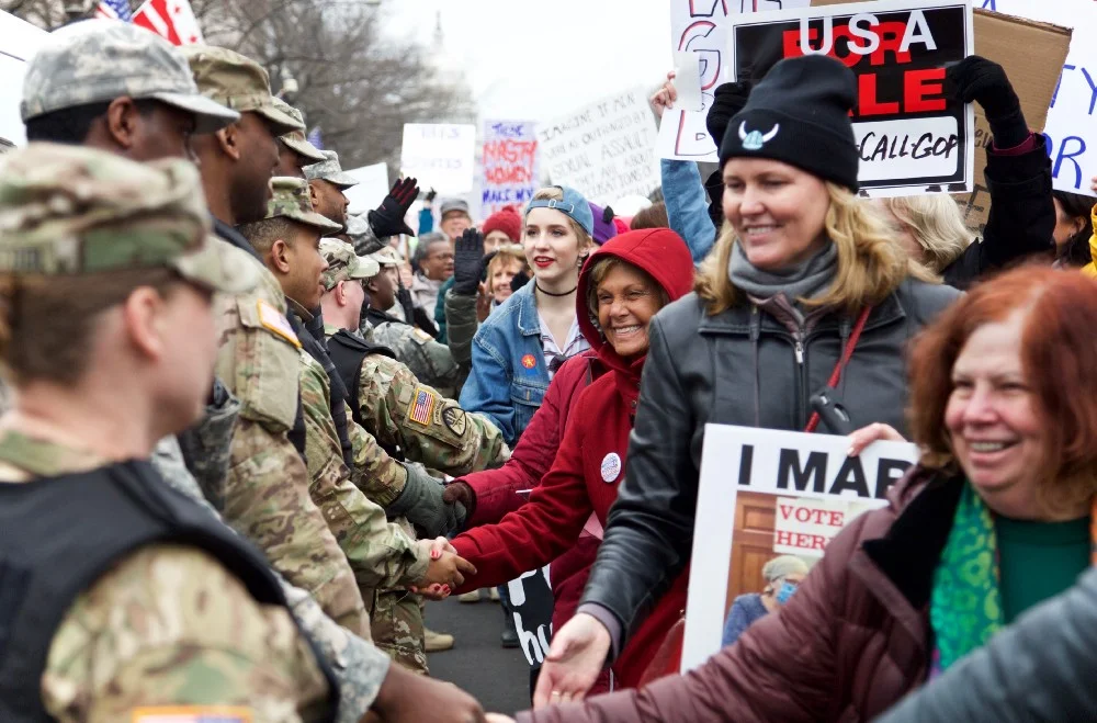 Participants in the Women’s March in Washington D.C. forming a gratitude line to shake hands with members of the National Guard. Photo by author.