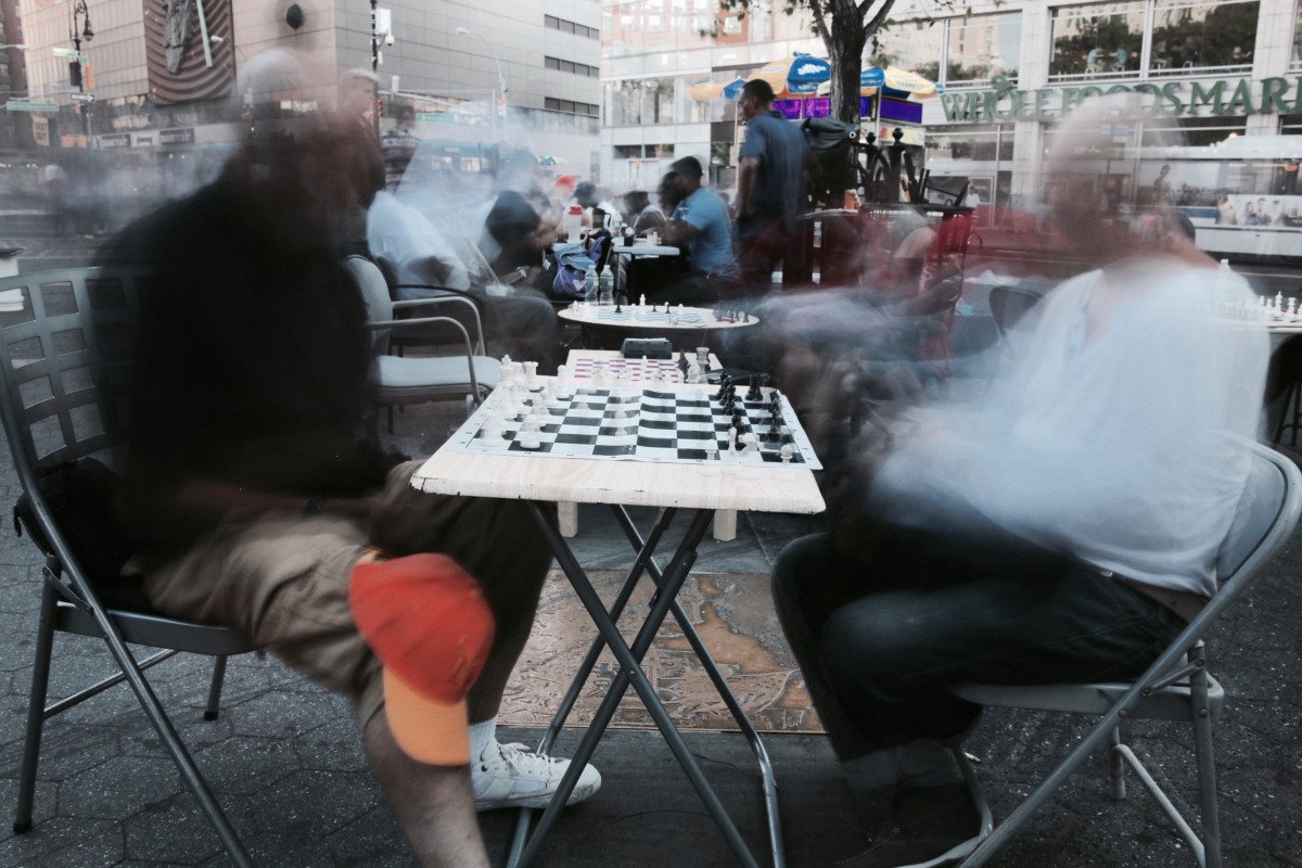 A long exposure image of chess players in Union Square, NYC. Summer 2016. Photograph by the author.