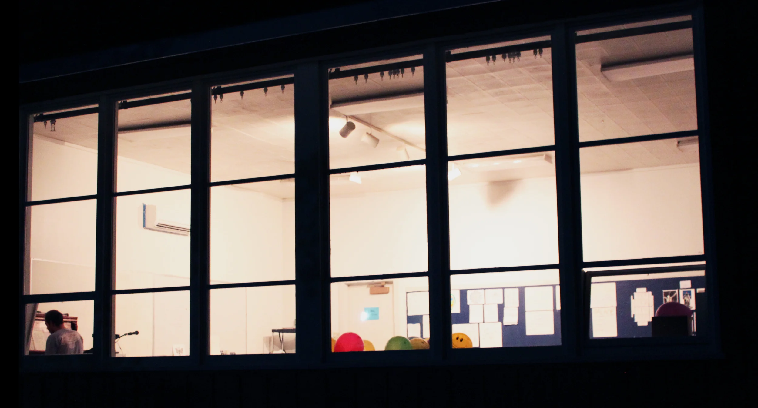 photograph by Rachel Baxter of Richard Aufrichtig at the piano in a studio space in Sitka, Alaska