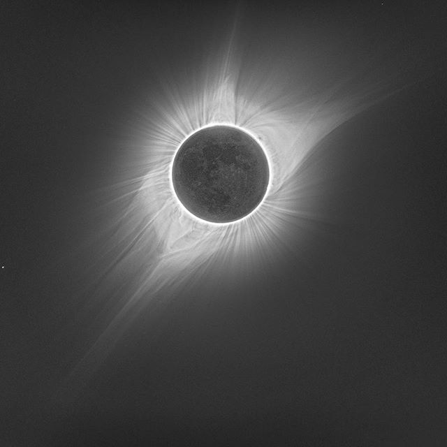 This is a HDR image of the solar eclipse. A composite image of several photos taken at a wide range of exposures reveals details in the bright chromosphere, the far reaching corona, and even the moon all at the same time. The delicate, dynamic tendri