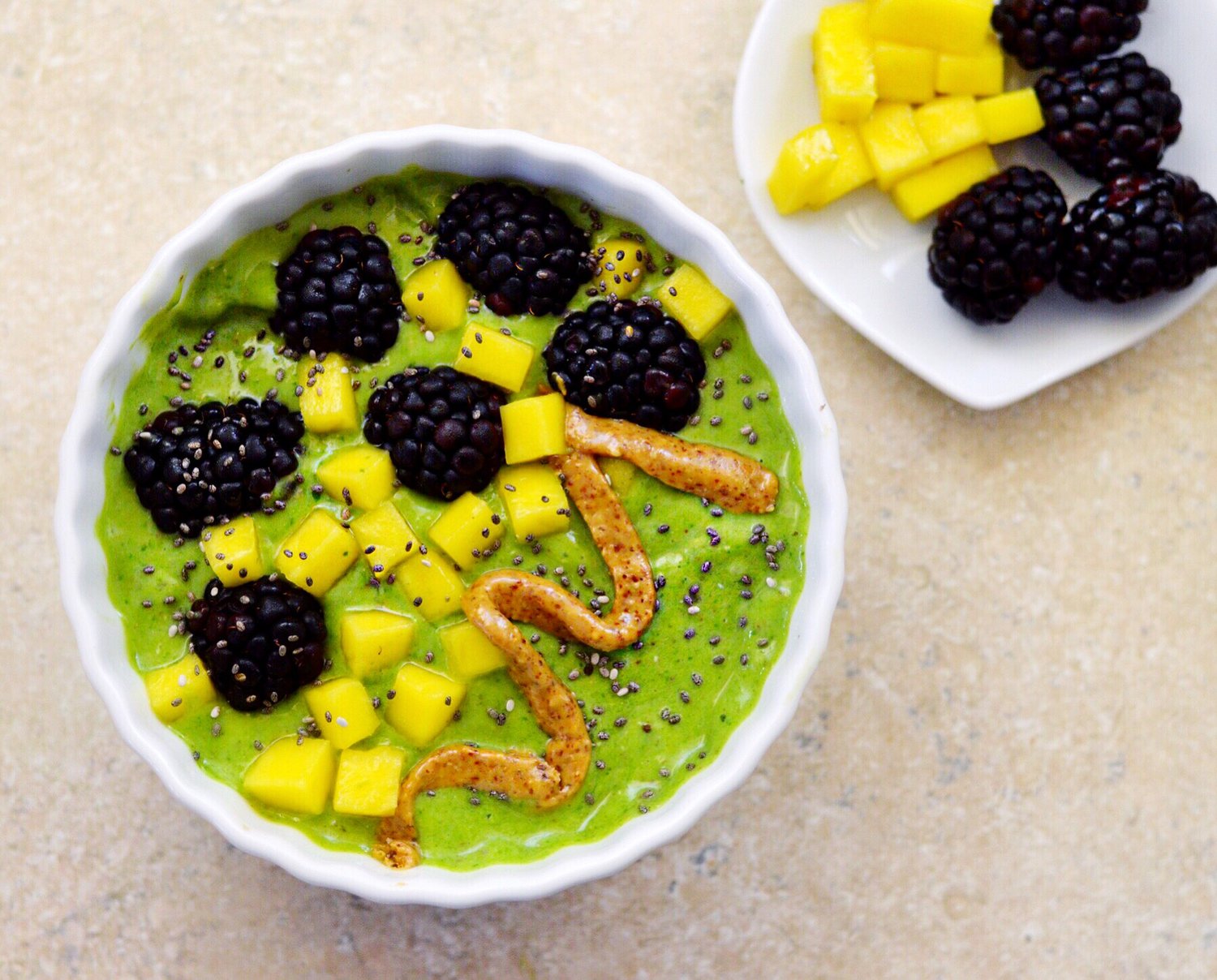 green smoothie bowl with blackberries mango almond butter