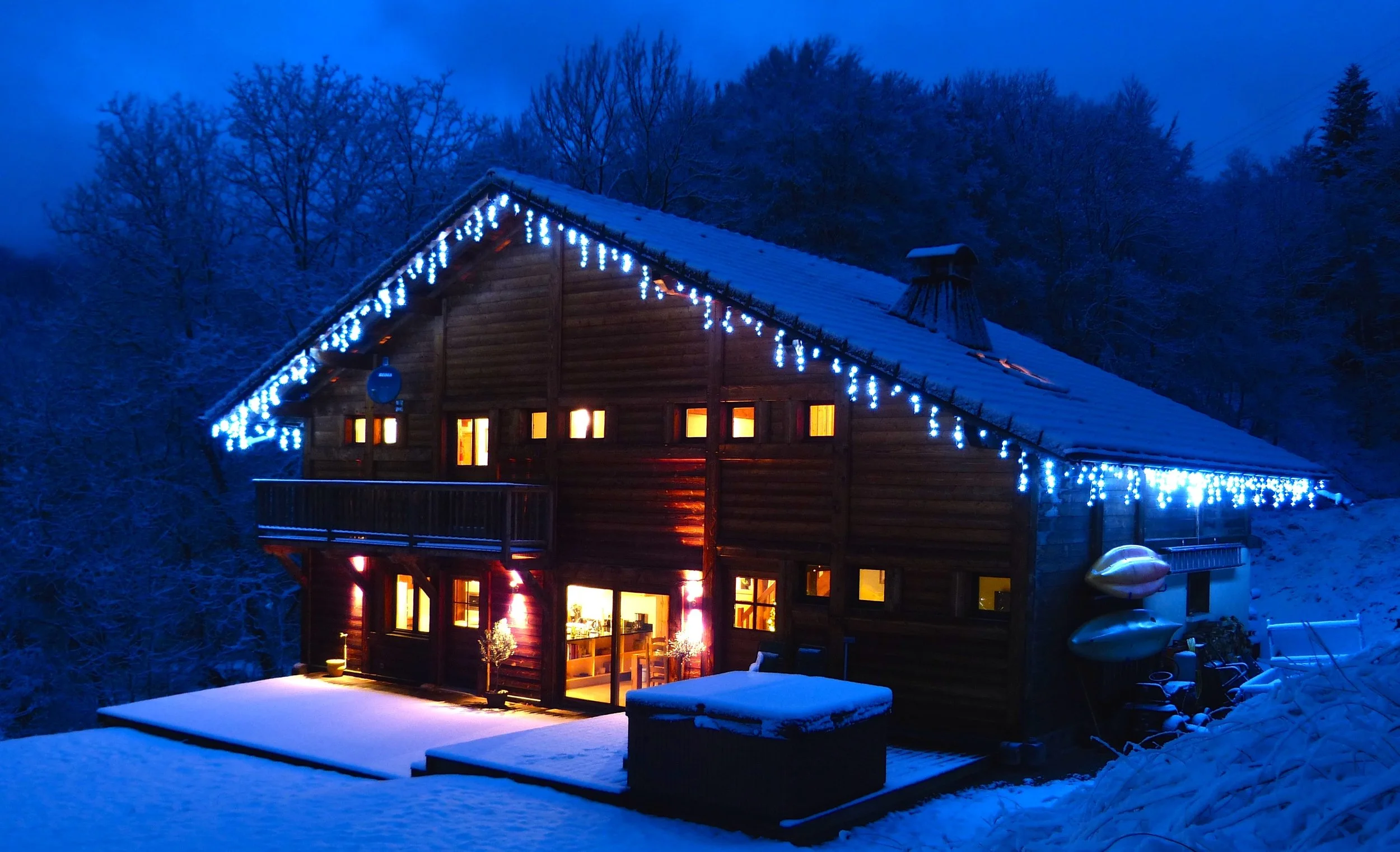 Chalet Le Pery covered in snow on a winter evening in the French Alps