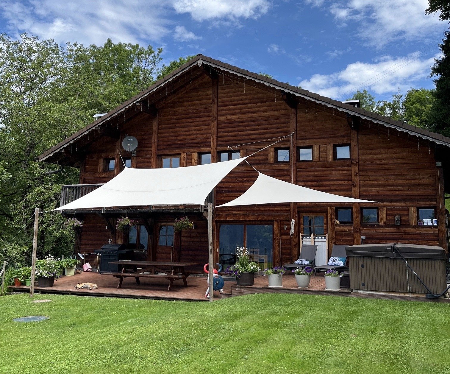 Chalet Le Pery in summer with garden, terrace and outdoor seating in the French Alps