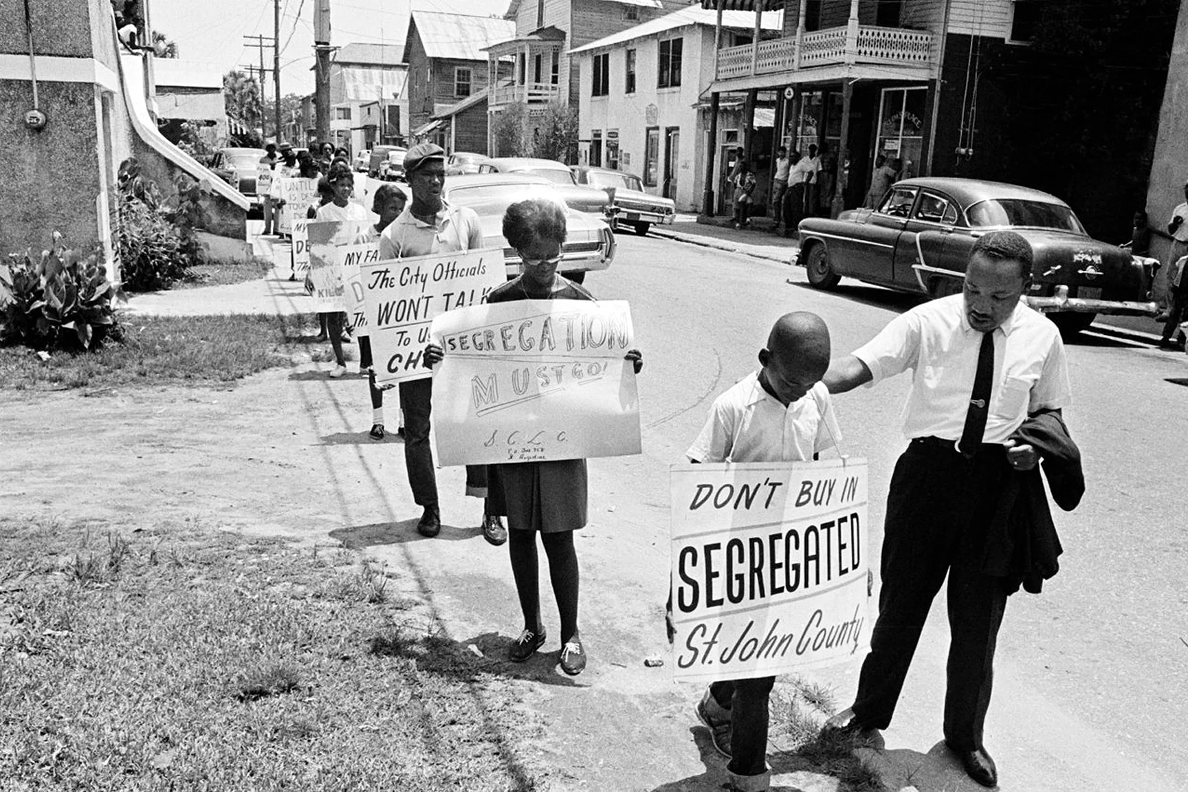 Local residents march in the streets encouraged by Dr. King.