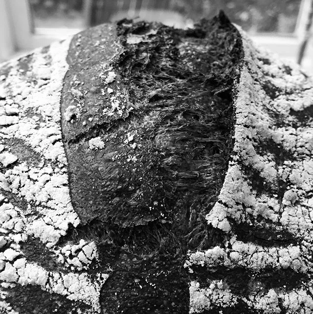 Charcoal Loaf, 70% Hydration. Love how different this looks. Crumb is pretty sweet.