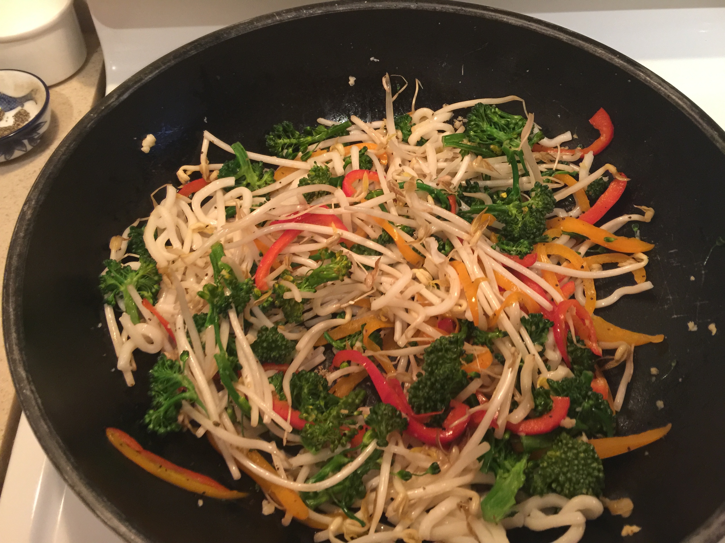 Add the udon noodles lastly, as they will cook up quickly. Follow it with the sauces and a splash of water. 