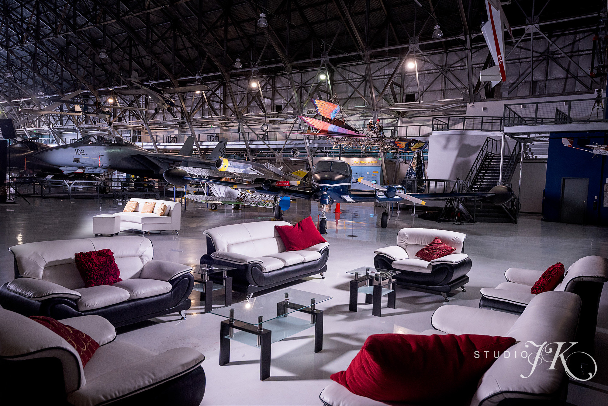 Contemporary Black and White Leather with rolled arms. Couches, loveseats, armchairs and glass topped tables with wood accents. The Numbers: 2 Couches, 2 Loveseats, 2 Armchairs, 2 Coffee tables, 2 End Tables. (Photo Courtesy of Studio JK )