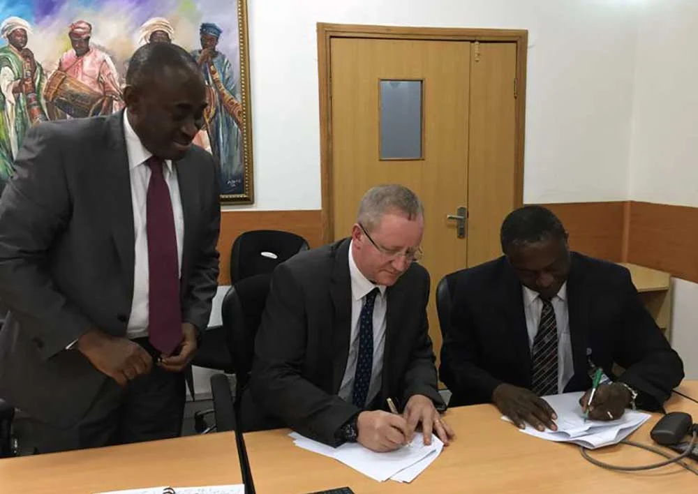 Gede Foundation Managing Director, John Minto, and IHVN CEO, Dr. Patrick Dakum, signing a letter of agreement between the two organizations.