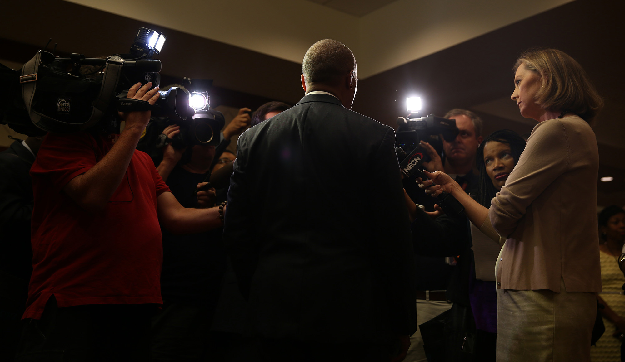 Massachusetts Gov. Deval Patrick, center, addresses reporters after speaking at the opening ceremony for the National Association of Black Journalists convention at the Hynes Convention Center in Boston, Mass., on Thursday, July 31, 2014. Gov. Patri