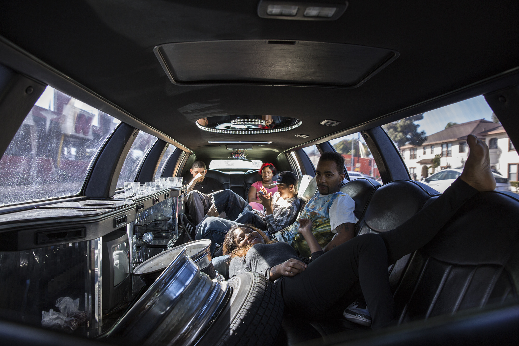 Dee Murry's niece and nephews ride in his limo with friends during the annual United in Peace Day ride in Leimert Park, Los Angeles, CA. Every month bikers and lowriders attend the United in Peace rides to spread a message of unity and peace in