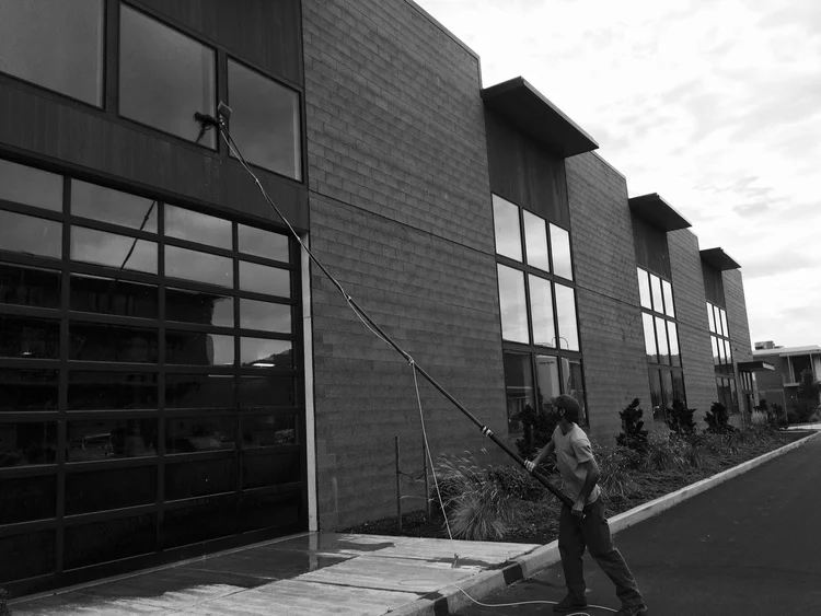 Cleaning windows using a water-fed pole at the Tofurky building in Hood River.