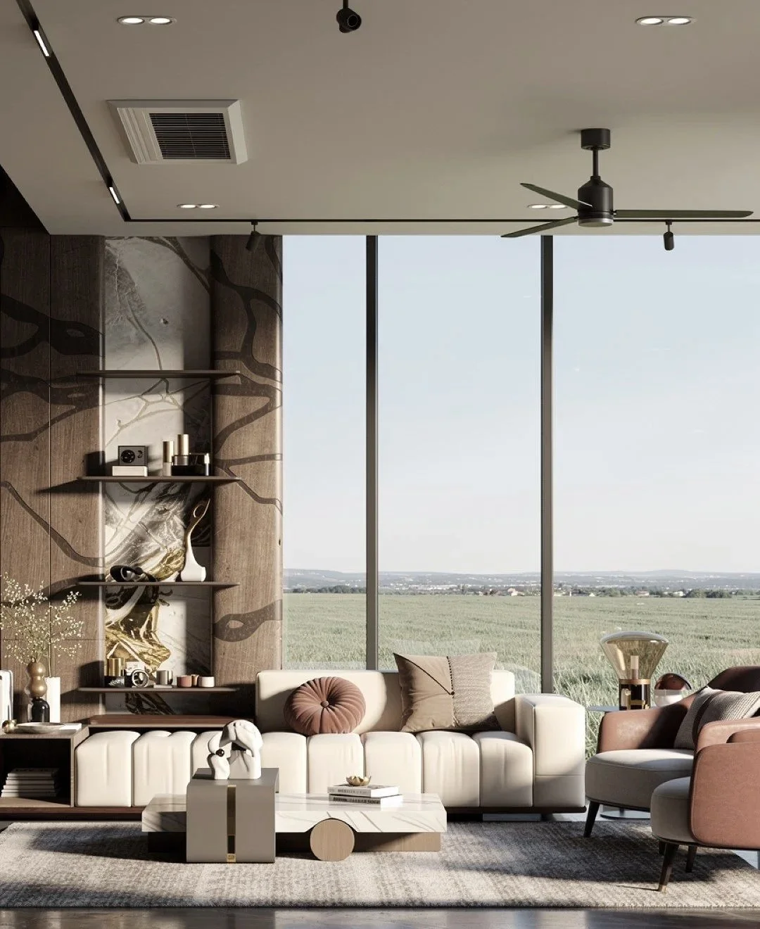 Modern living room with large floor-to-ceiling windows, white sofa with decorative pillows, pink and beige armchairs, contemporary coffee table, decorative shelves with art and accessories, and open view of a green field outside.