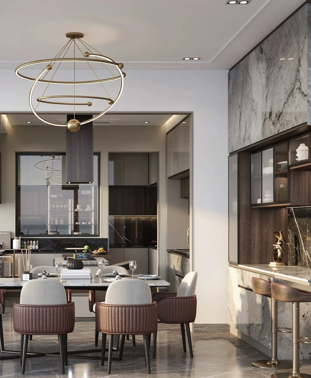 Modern kitchen and dining area with a circular crystal chandelier, beige and brown upholstered chairs, a black marble table set with glasses and dinnerware, and sleek beige cabinetry.