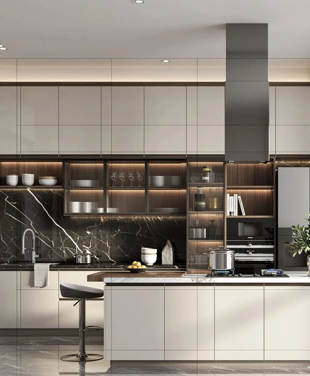 Modern kitchen with beige cabinets, black marble backsplash, and glass-front upper shelves illuminated by warm lighting. Contains a stove, pot, bowl of lemons, and decorative items.