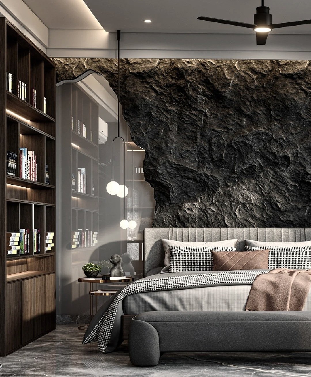 Modern bedroom with a textured black rock wall, gray upholstered bed with checkered pillows, a small side table with decorative objects, a wooden bookshelf filled with books, and a ceiling fan with lights.
