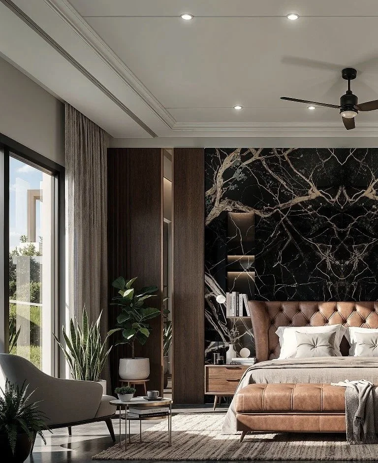 Modern bedroom with large sliding glass door, beige curtains, black marble accent wall with gold veining, wooden headboard, white bedding, brown leather bench at foot of bed, nightstand, tabletop lamp, potted plants, ceiling fan, recessed lighting, a
