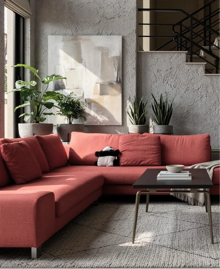 A modern living room with a red sectional sofa, a black coffee table, beige walls, abstract artwork, a sliding glass door, and a staircase.