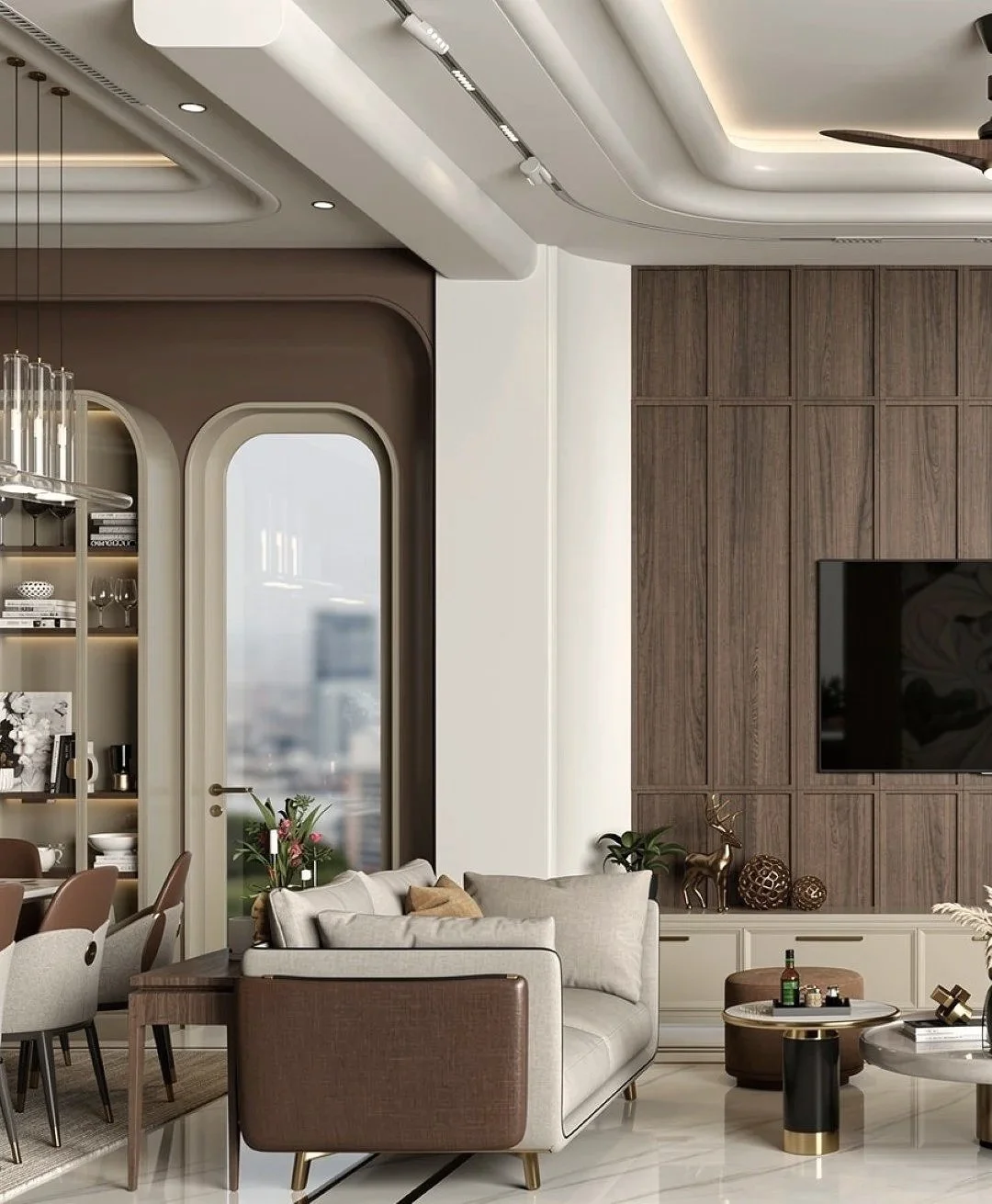 Modern living room with a beige sofa, a wooden coffee table, and a dark wood accent wall with a mounted flat-screen TV. Sunlight casts shadows on the white wall and floor. A decorative item and plant are on a white cabinet, with a gold and white side