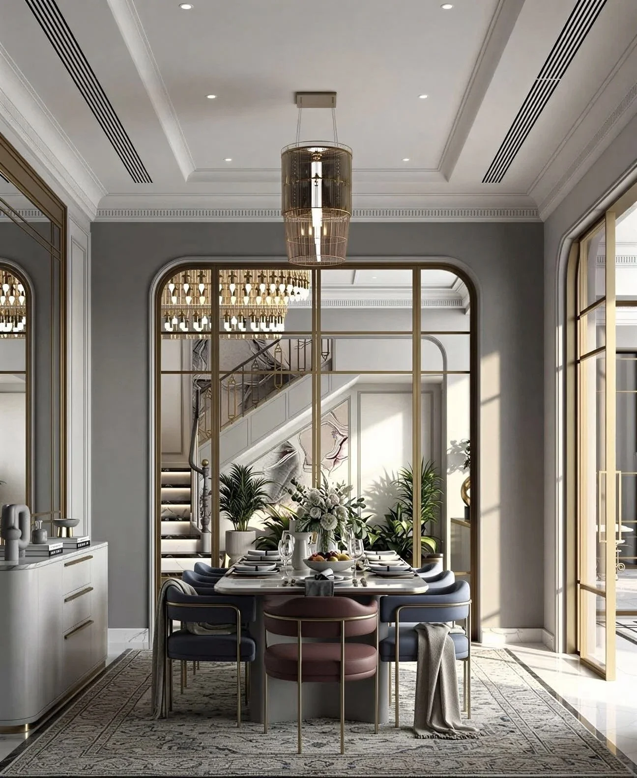 Elegant dining room with a black table, cream upholstered chairs, and decor including placemats, plates, wine glasses, and vases with greenery. Large windows and a staircase with plants visible outside.