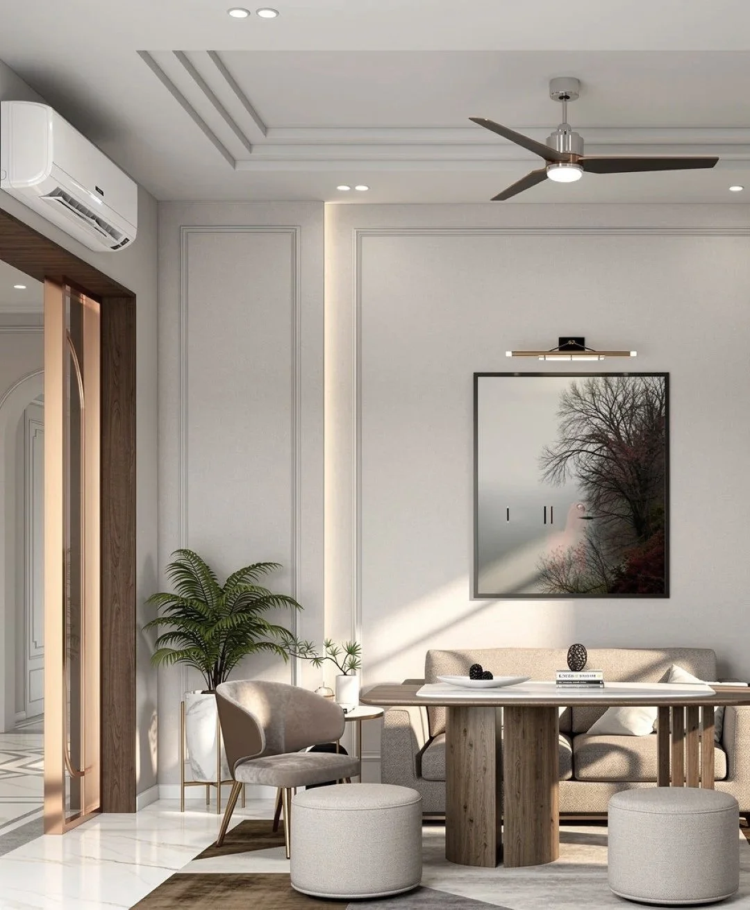 Modern living room with beige walls, a ceiling fan, a wall-mounted air conditioner, a large mirror reflecting a tree outside, a beige sofa, a round wooden table, a gray armchair, an ottoman, and green plants.