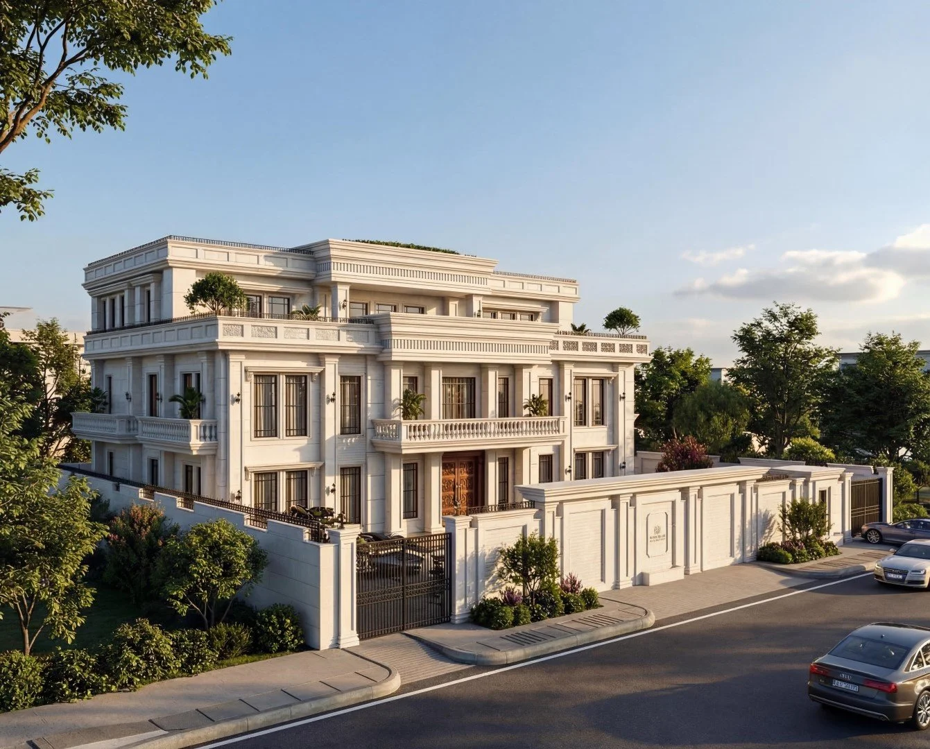 Large elegant white mansion with multiple balconies and a gated entrance, surrounded by green trees and parked cars, under a clear blue sky.