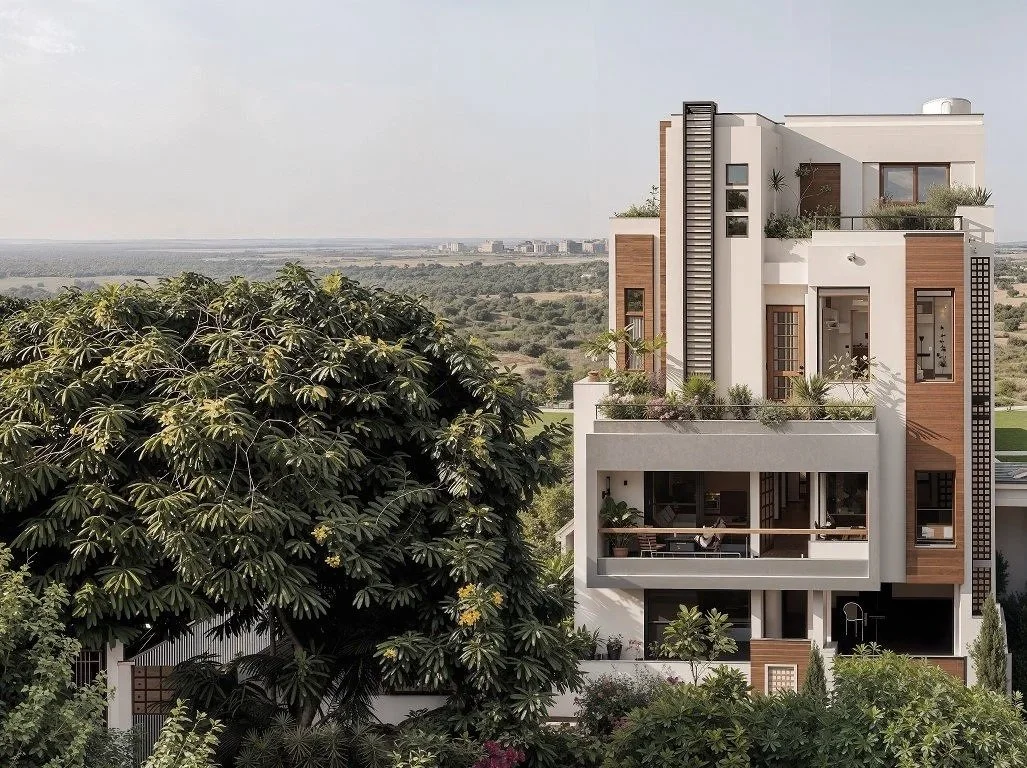 Modern multi-story house with large balconies and rooftop garden, set against a scenic landscape with a large tree in the foreground.