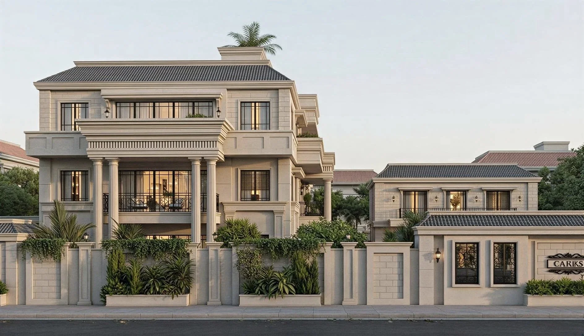 Luxury multi-story house with beige exterior walls, black tiled roof, large windows with black frames, decorative columns, and balconies, surrounded by a white wall with lush green plants.
