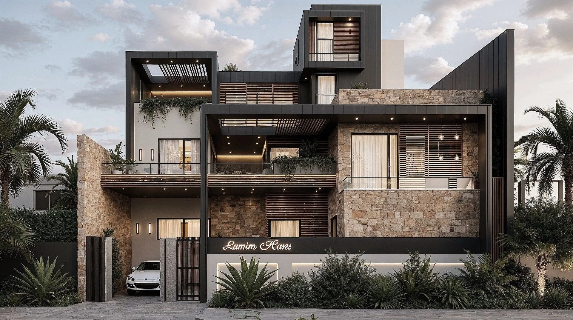 Modern multi-story building with stone and black panel exterior, surrounded by palm trees and shrubs, with a white car parked at the entrance and a sign that says "Lamin Homes".
