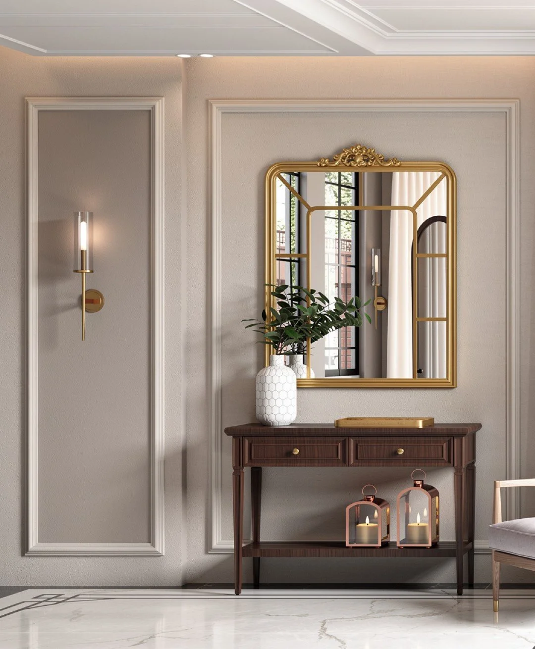 A stylish interior hallway features a dark wooden console table with a white hexagon-patterned vase holding green foliage, a gold framed mirror, and two lantern-style candle holders on the lower shelf. The wall is adorned with elegant white molding a