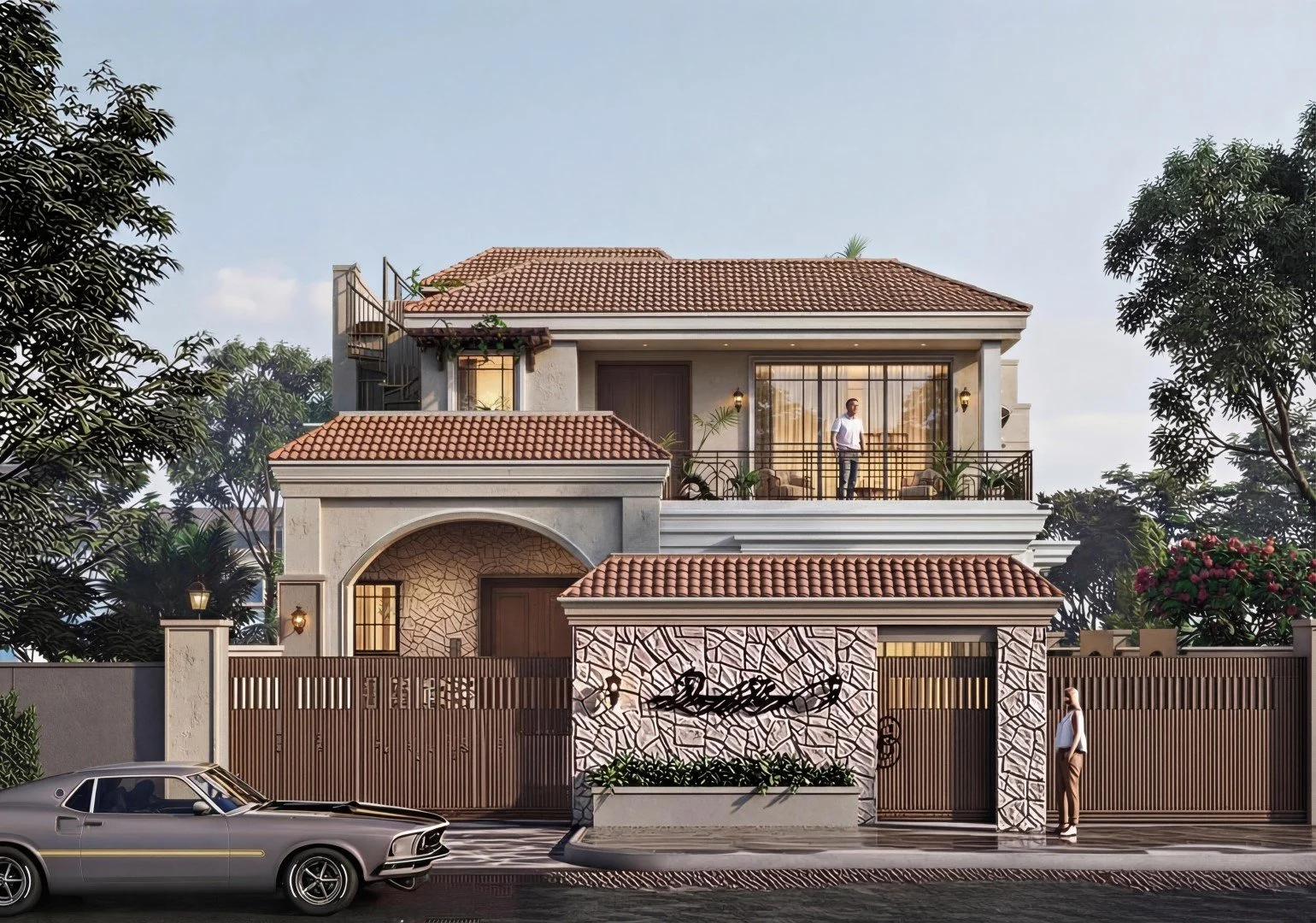A modern, multi-story house with a tiled roof, a balcony with glass doors, and a gated entrance. There is a person standing on the balcony and another person standing near the gate. A vintage car is parked in front of the house, and there are trees and flowers around the property.