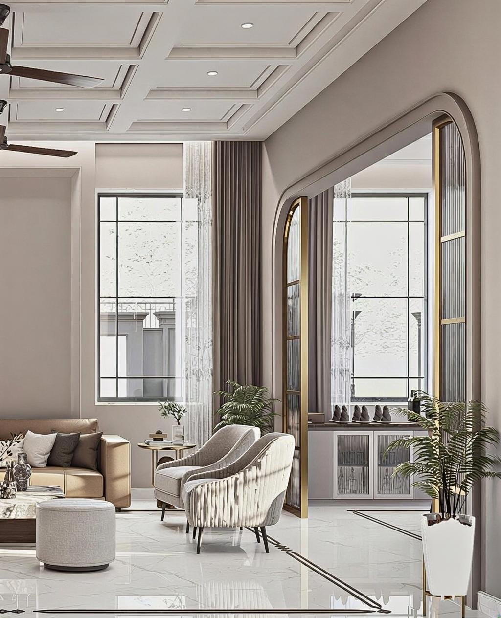 Modern living room with large windows, elegant beige and gray furniture, decorative plants, and gold accents.