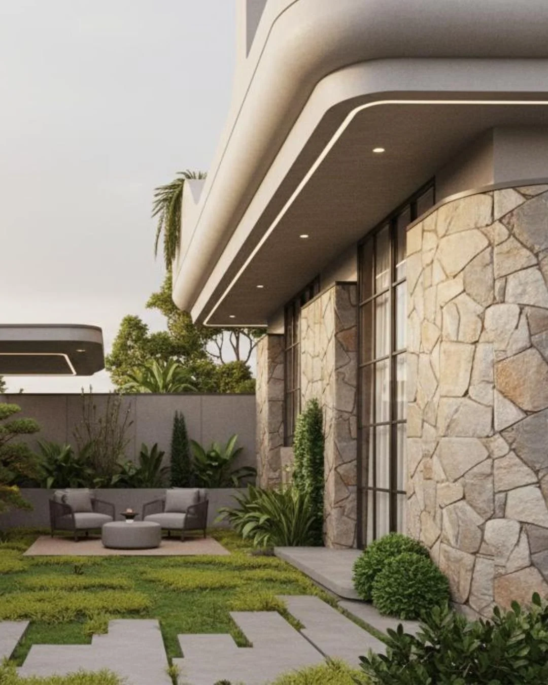 Modern house with stone wall exterior, glass windows, and a landscaped backyard with outdoor seating, plants, and a pathway.