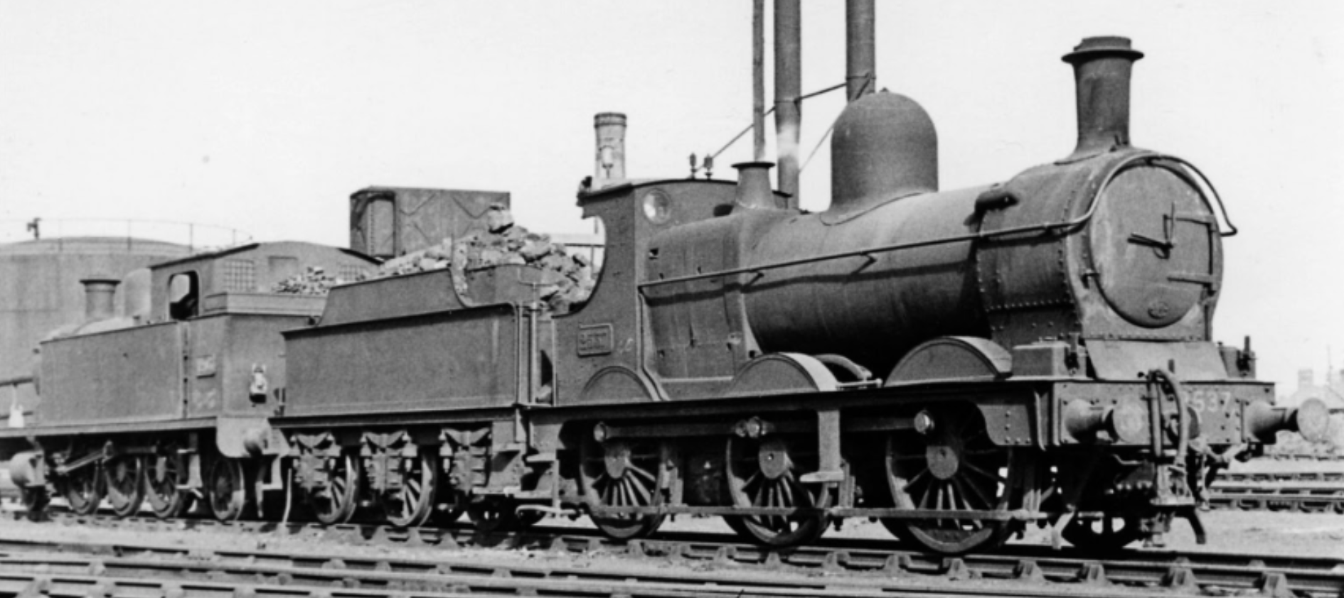 Who doesn’t love a Dean Goods? A view of Cardiff Canton on 15th April 1951 with two pre-grouping locos in the yard. Nearest the camera is Dean Goods 0-6-0 No. 2537 and behind is Alexandra Docks Railway 2-6-2T No. 1205, which was used as shed pilot until it was withdrawn in 1955. Photo: Ben Brooksbank Creative Commons Attribution