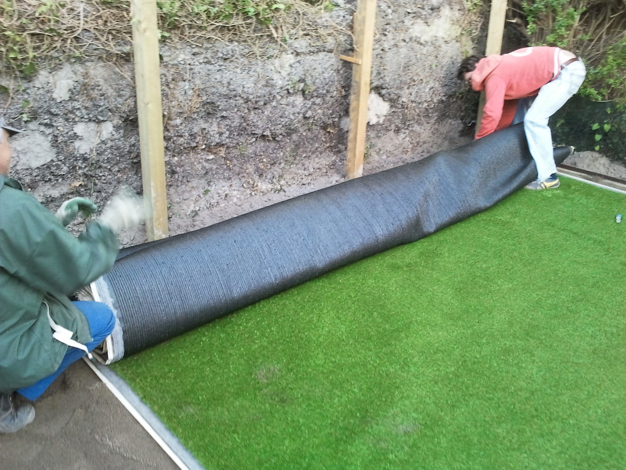 Installers fitting grass turf