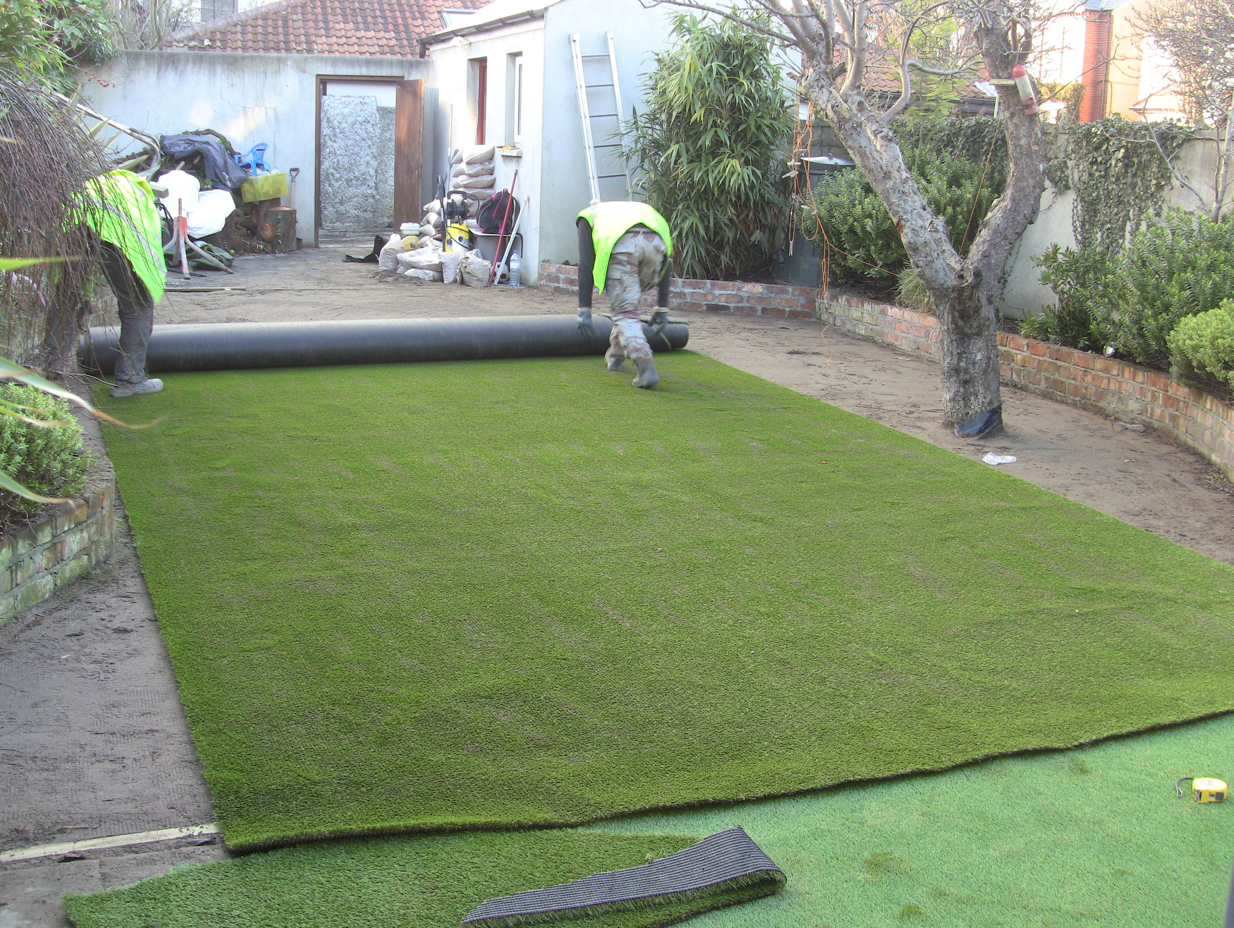 installers rolling out new lawn