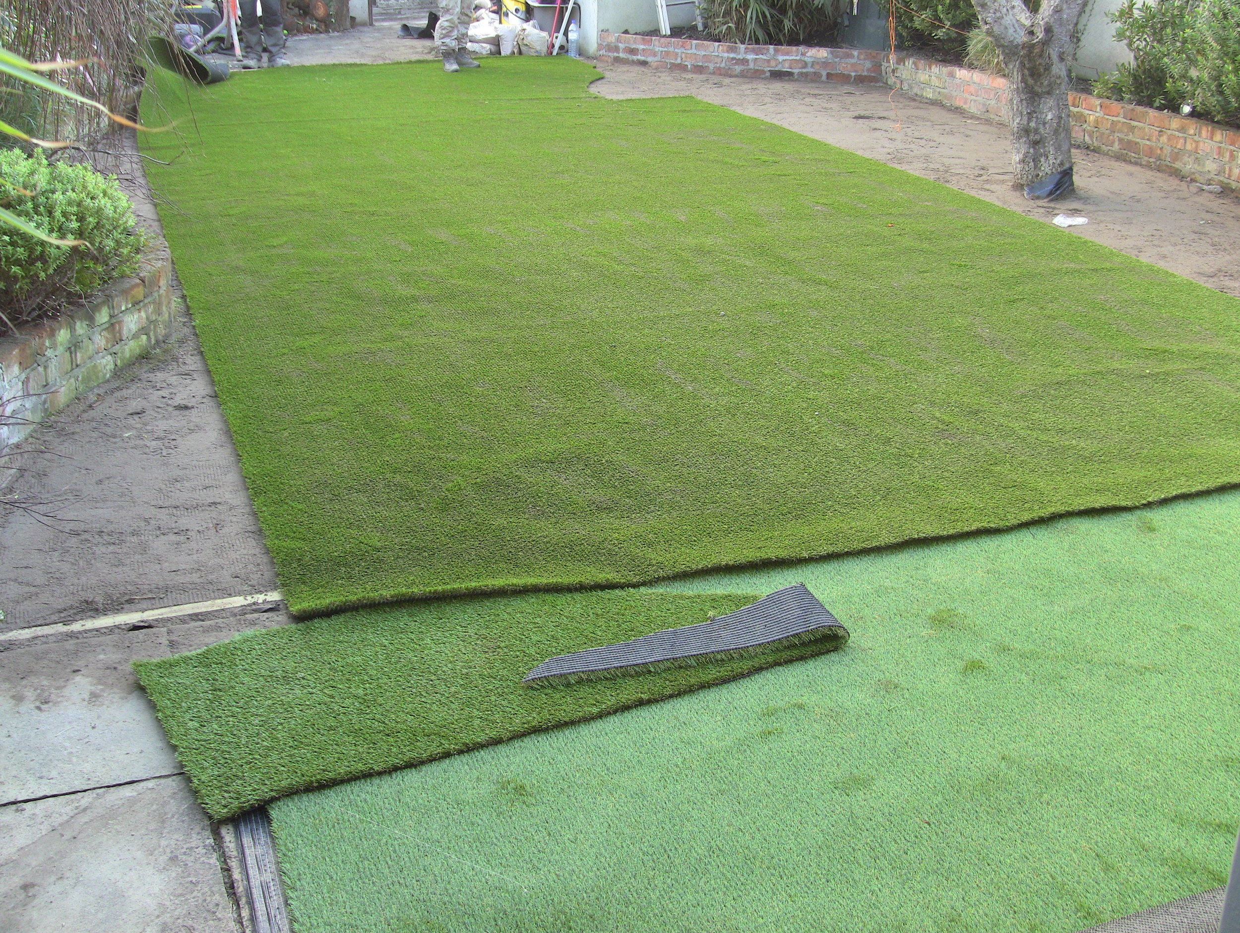 new artificial lawn being fitted