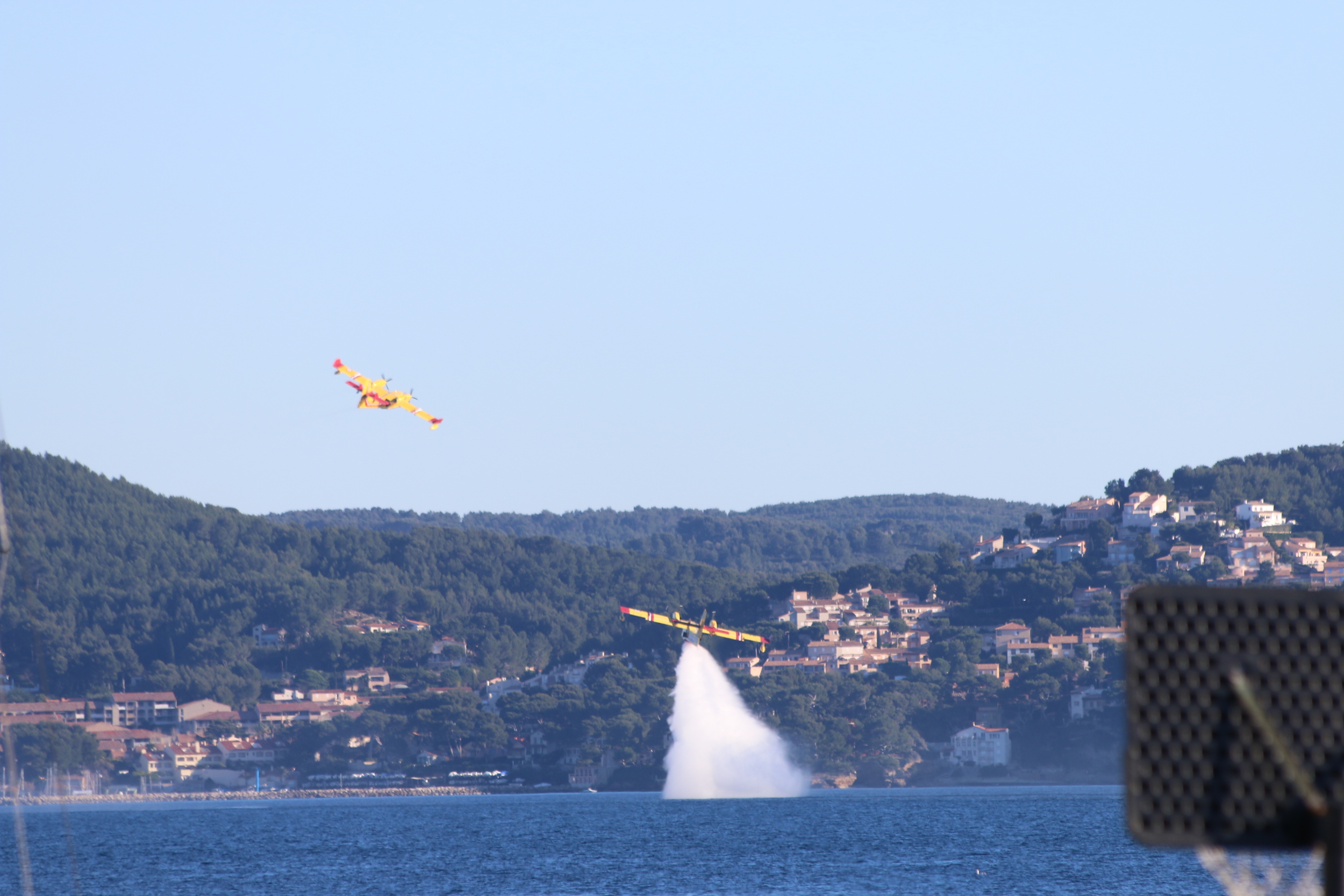 La Ciotat: fire fighting planes practicing filling and emptying water tanks.